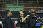 A staff member helps a graduate