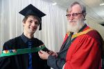 Professor Heinz Beckedahl gets his son Derrick ready for graduation