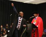 Lindokuhle Ntombela raises a fist in the air as he receives his BSc Honours in Physics summa cum laude