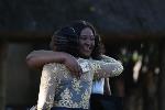 Congratulatory hugs shared between graduates