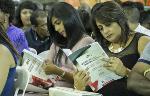 Family members peruse the graduation programmes