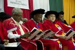 The academic procession seen onstage perusing the graduation programme