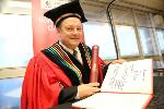 Professor Rob Slotow signs his fellowship to UKZN